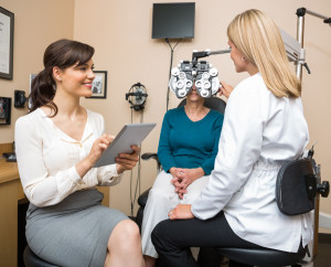 Ophthalmologists Examining Senior Woman In Store